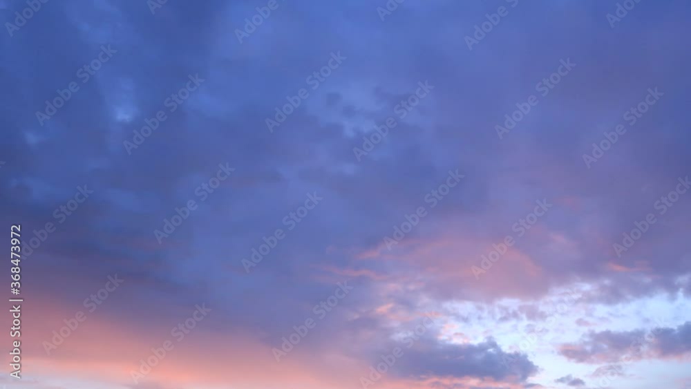 TimeLapse - Red purple pink & blue sunset sky with colorful pastel clouds & orange cloudscape slowly moved on evening twilight horizon in tropical summer or spring sunlight & sun ray at sunshine day TimeLapse - Red purple pink & blue sunset sky with colorful pastel clouds & orange cloudscape slowly moved on evening twilight horizon in tropical summer or spring sunlight & sun ray at sunshine day