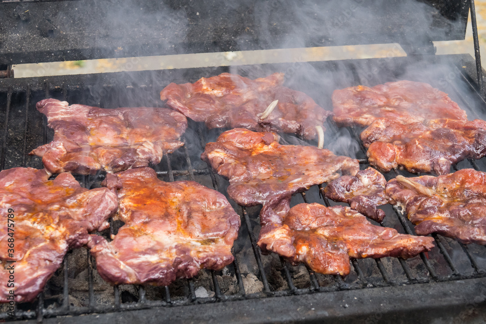 Tasty steaks on barbecue. Meat during grilling. Tasty steaks on barbecue. Meat during grilling.