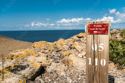 A wooden sign on the Cami de Cavalls (horses walk) coastal walk in Minorca island.