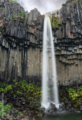 Vertical view of the waterfall Svartifoss, the black falls, located in Skaftafell in Vatnajökull National Park in Iceland. 