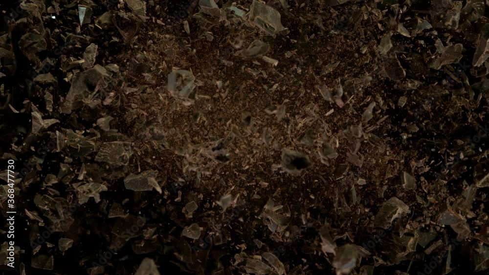 Super slow motion of flying group of raw chocolate pieces. Filmed on high speed cinema camera, 1000fps. Super slow motion of flying group of raw chocolate pieces. Filmed on high speed cinema camera, 1000fps.