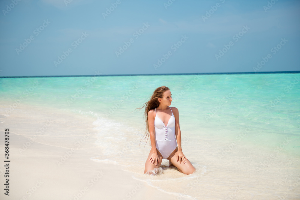 Portrait of her she nice-looking attractive slim fit long-haired girl enjoying sunny day good weather seaside luxury resort spa tour tourism sitting on sand clean clear water Portrait of her she nice-looking attractive slim fit long-haired girl enjoying sunny day good weather seaside luxury resort spa tour tourism sitting on sand clean clear water
