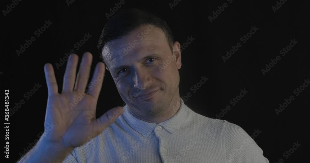Successful rich man is smiling and hand weaving on black background. Businessman, leader concept with handsome guy. Successful rich man is smiling and hand weaving on black background. Businessman, leader concept with handsome guy.