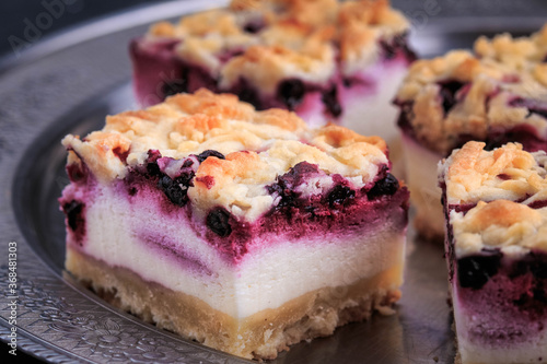 Homemade Blueberry Pie Bars. Delicious Crumble Bars on dark background.