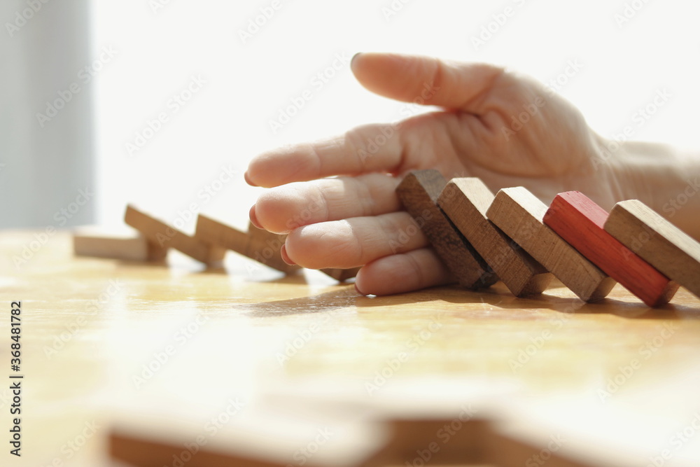 hand holding domino