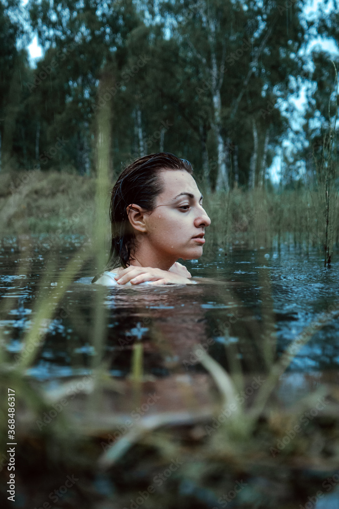 Beautiful young woman in in the forest lake