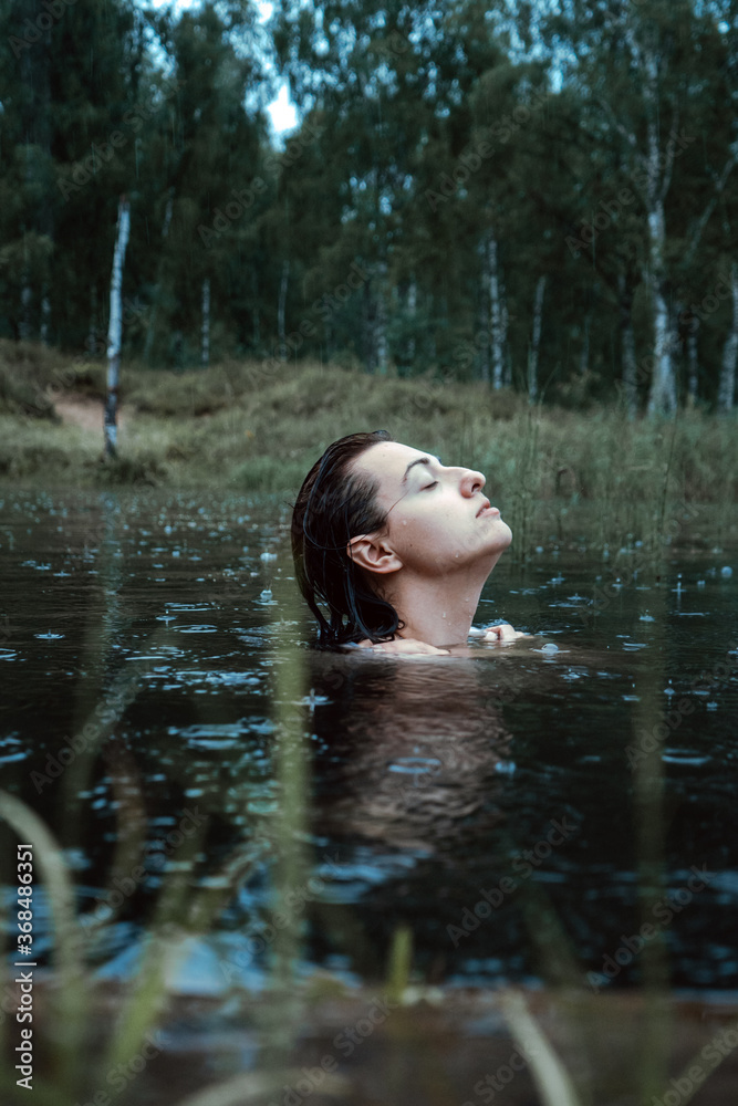 Fototapeta premium Beautiful young woman in in the summer lake