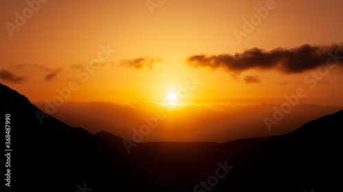 Panoramic view of a beautiful and stunning sunset in the mountains in Peñitas viewpoint, Fuerteventura, Canary Islands, Spain.