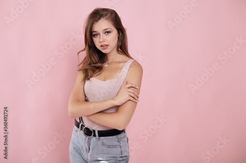 Girl in jeans on a pink background