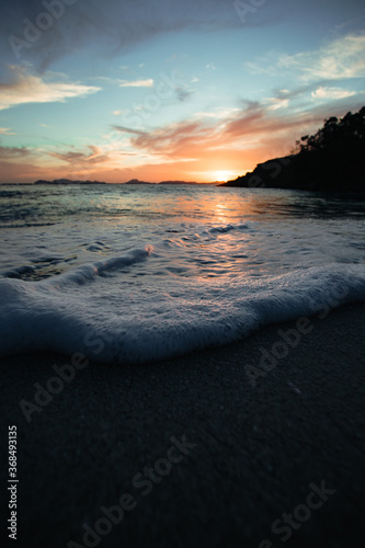 The foam of the tide coming to the camera during a sunset photo