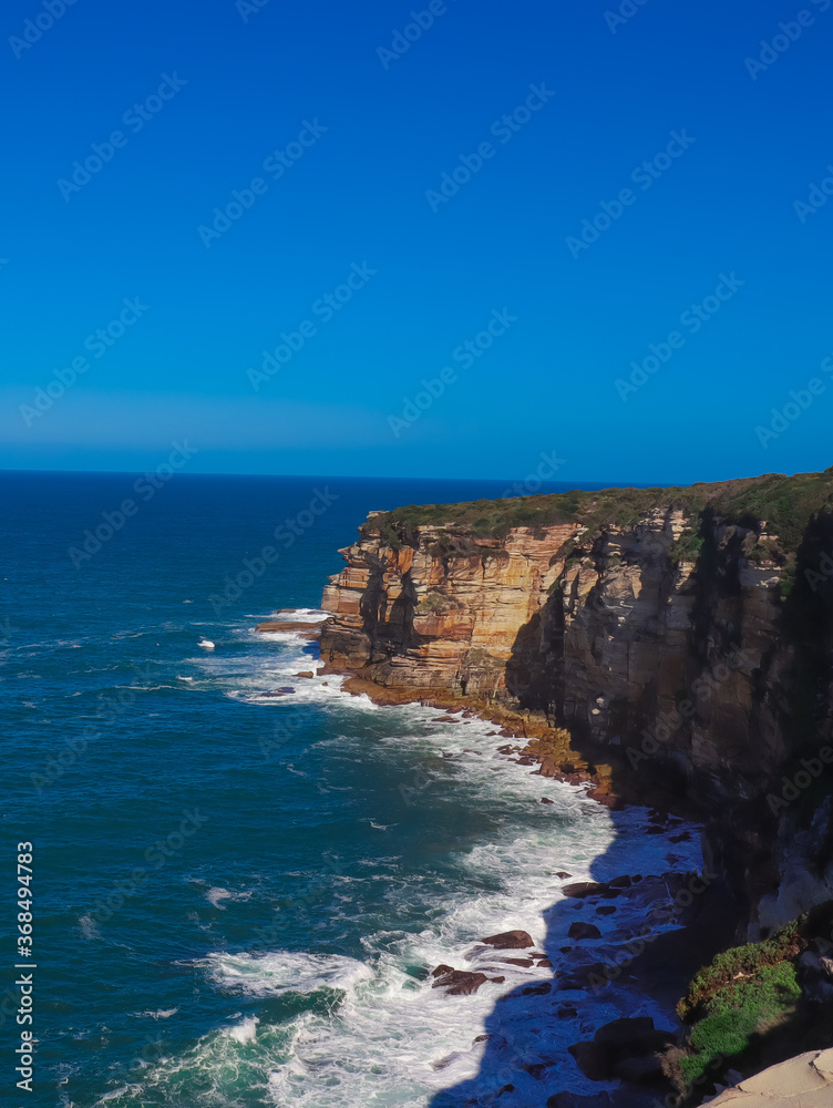 Rock cliffs in Sydney Australia national park blue skies and oceans 