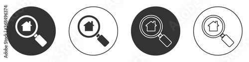 Black Search house icon isolated on white background. Real estate symbol of a house under magnifying glass. Circle button. Vector Illustration.