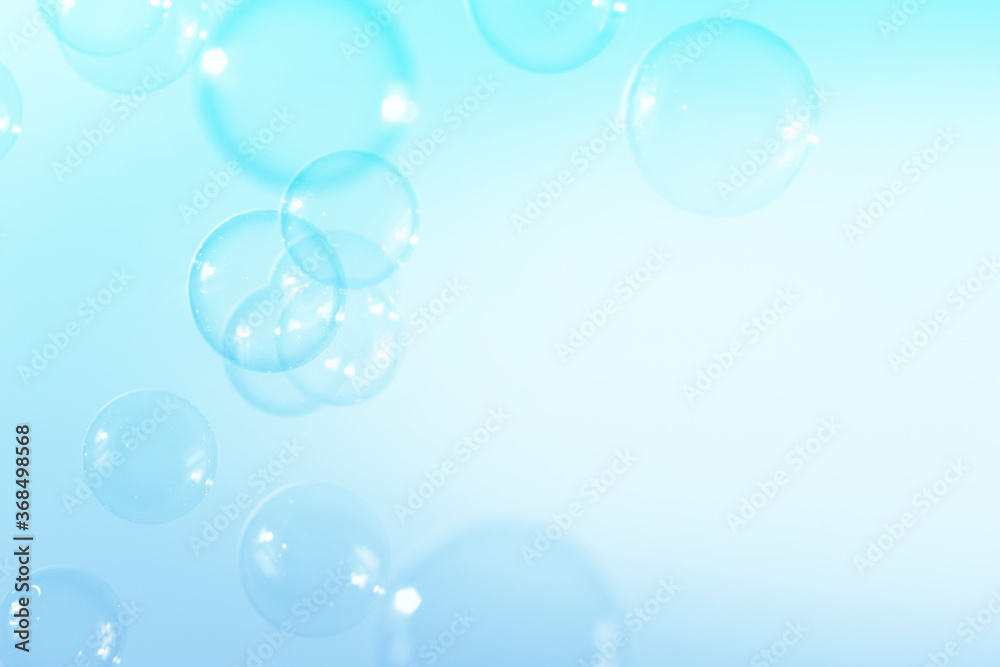 Blue soap bubbles float background, with copy space a white background