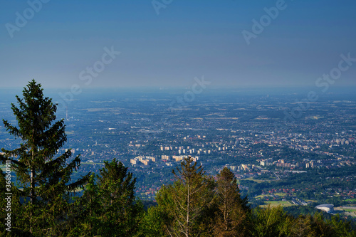 Bielsko Biala, South Poland: Wide angle from up above panoramic detailed high definition view of scenic mountains, green forest and city against blue sky © Arpan