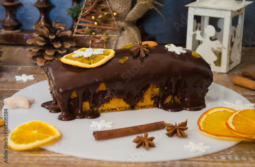 Chocolate orange Christmas cake with fir tree and other decoration