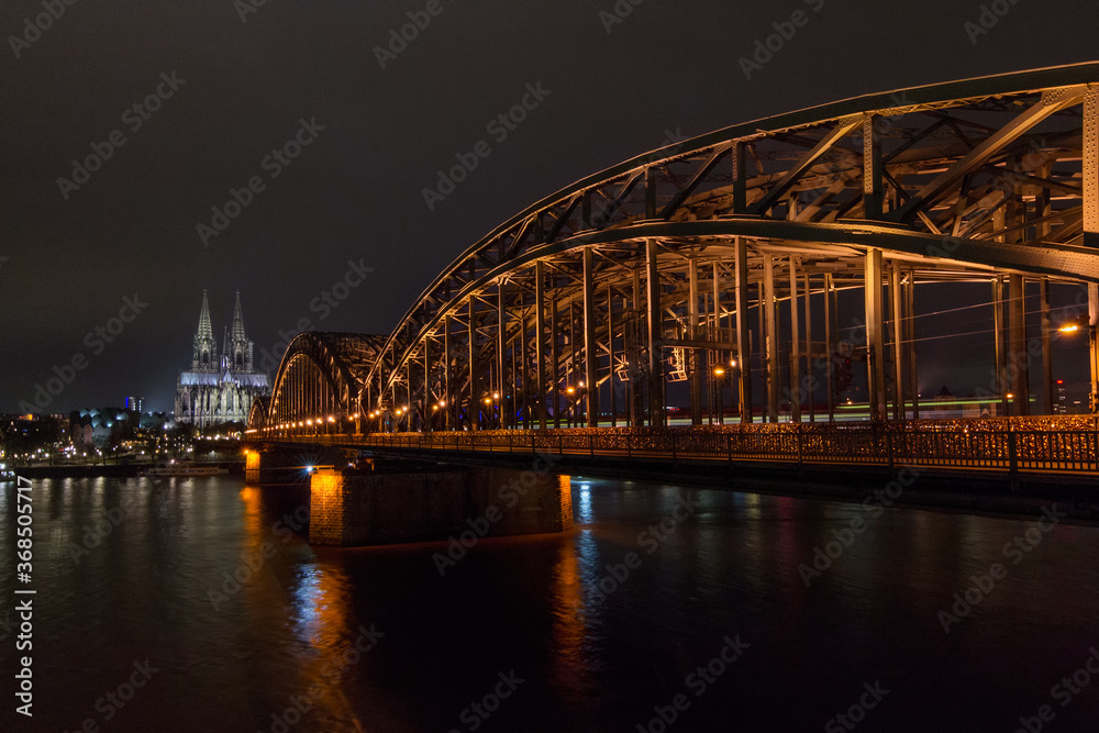 Night view of the Cologne Hohenzollern Bridge and Cologne Cathedral over the Rhine river