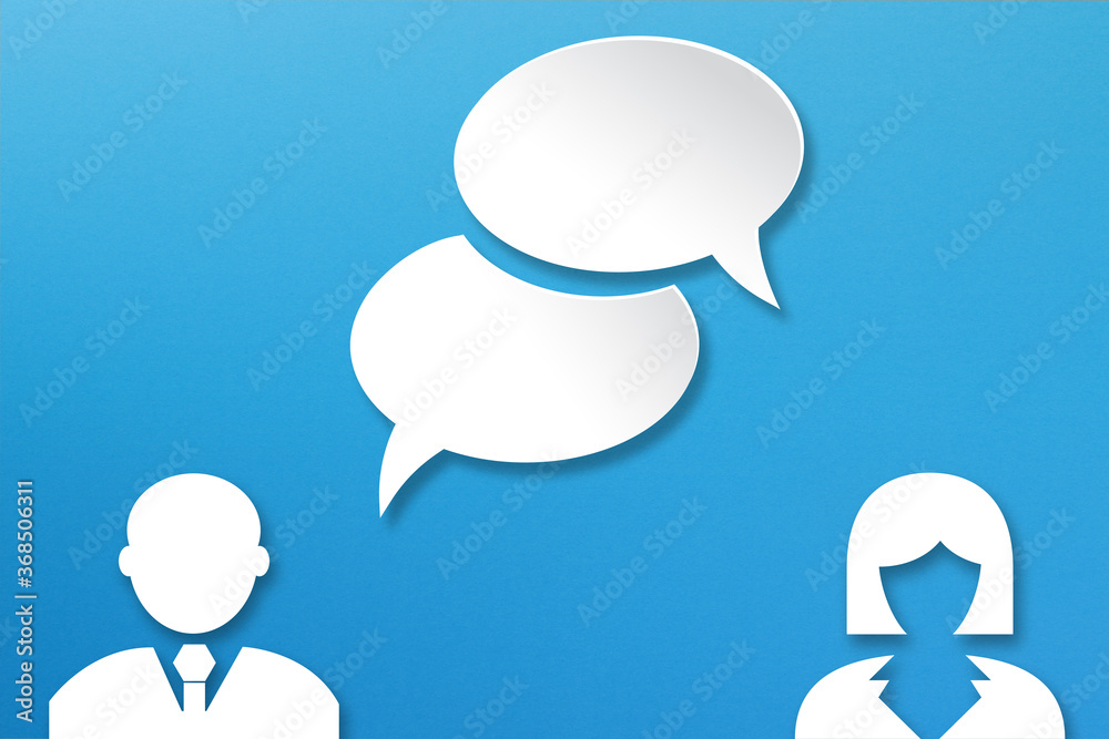 Blank white speech bubbles with businessman and businesswoman icons paper cut on blue background Blank white speech bubbles with businessman and businesswoman icons paper cut on blue background