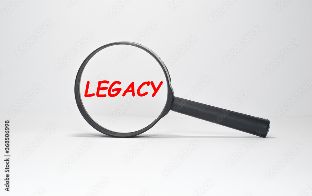 Legacy text, inscription, phrase is written in a notebook that lies on a dark table and a pen. Business concept. Legacy text, inscription, phrase is written in a notebook that lies on a dark table and a pen. Business concept.