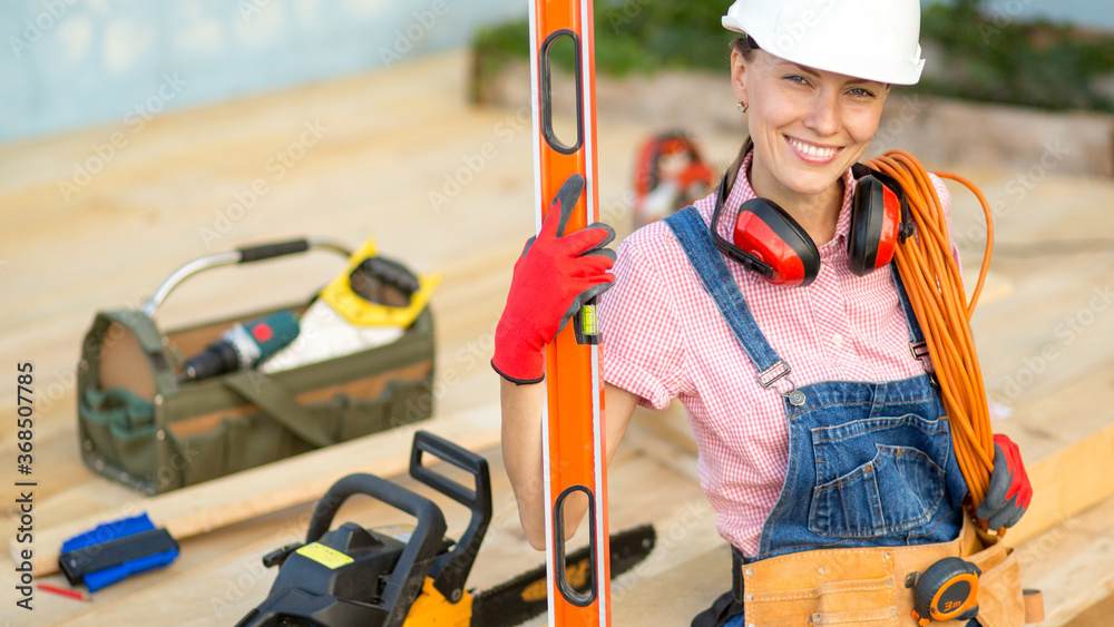 Carpenter woman is at work. Building as a hobby. Beautiful woman with construction tools Carpenter woman is at work. Building as a hobby. Beautiful woman with construction tools