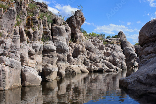 Adventure. Geology. View of the river flowing along the rocky cliffs called Los Elefantes in Mina Clavero, Cordoba, Argentina.