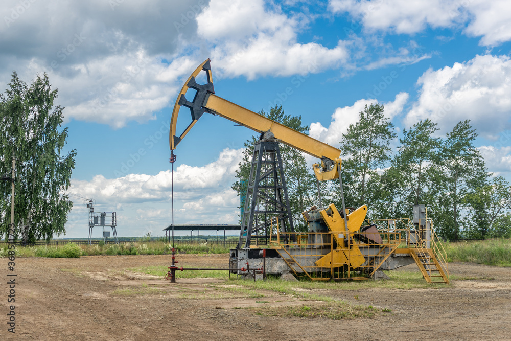 Oil pump. Oil industry equipment. Yellow oil pump in Russia Oil pump. Oil industry equipment. Yellow oil pump in Russia