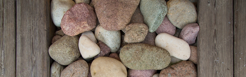 Picture with wooden planks and stones of different colors. Background/Textures. Italian design Picture with wooden planks and stones of different colors. Background/Textures. Italian design