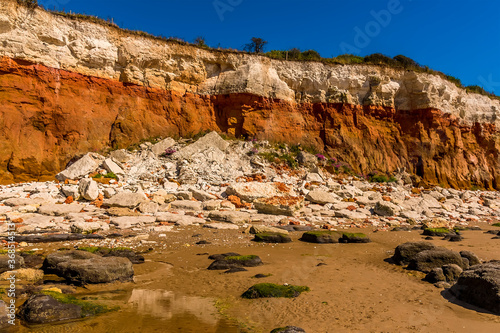 A major, recent rockfall from the white, red and orange stratified cliffs at Old Hunstanton, Norfolk, UK photo