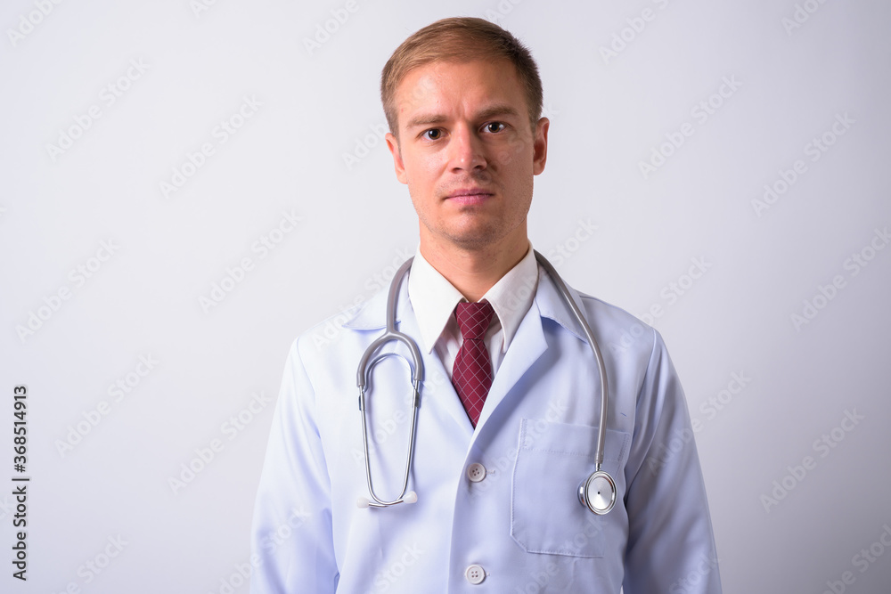 Portrait of handsome man doctor against white background Portrait of handsome man doctor against white background
