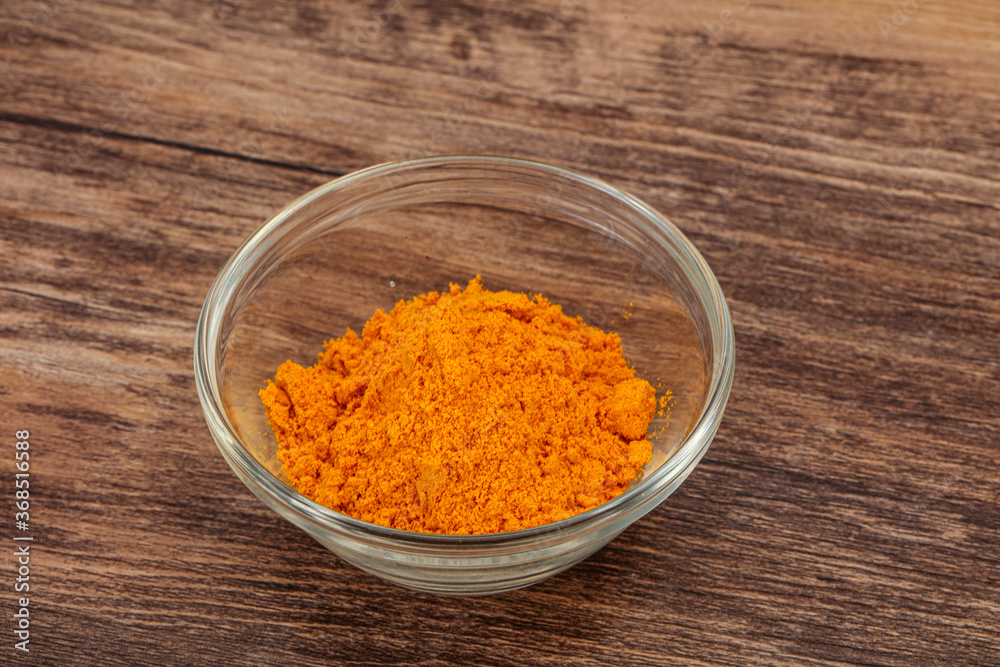 Tumeric powder in the bowl Tumeric powder in the bowl
