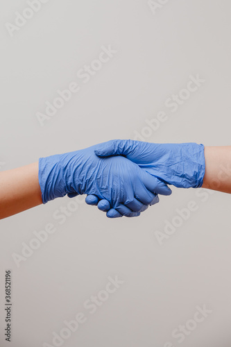 hanshake with gloved hands, protected from corona virus