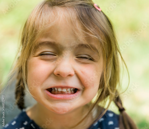 Girl with braided hair making a face