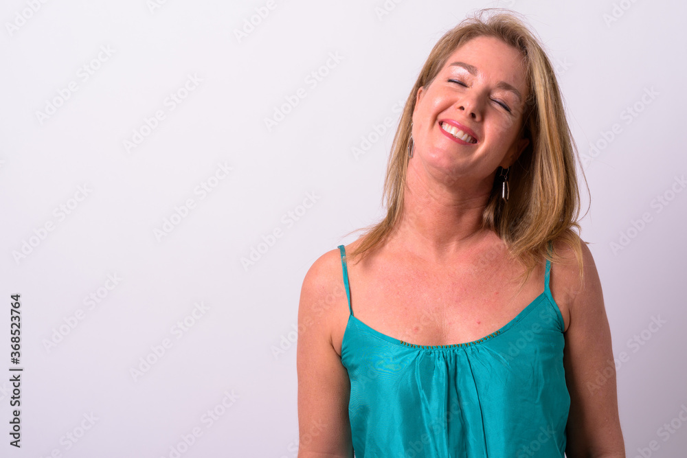Mature beautiful blonde businesswoman against white background Mature beautiful blonde businesswoman against white background