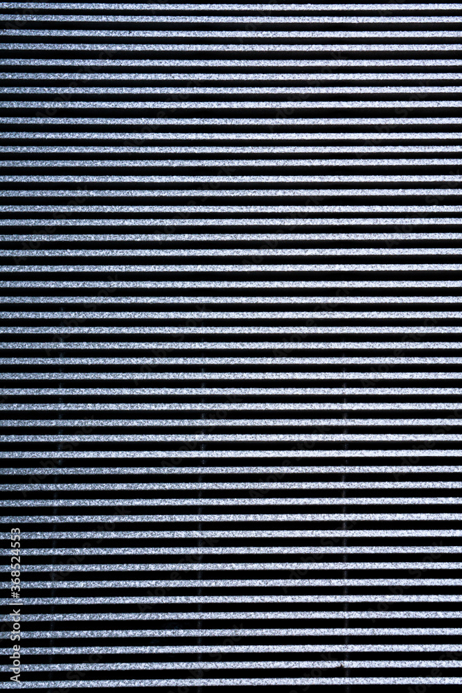 Corrugated gray metal panel on a wall. Textured, horizontal line pattern background with space for text Corrugated gray metal panel on a wall. Textured, horizontal line pattern background with space for text