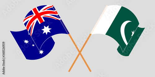 Crossed and waving flags of Pakistan and Australia