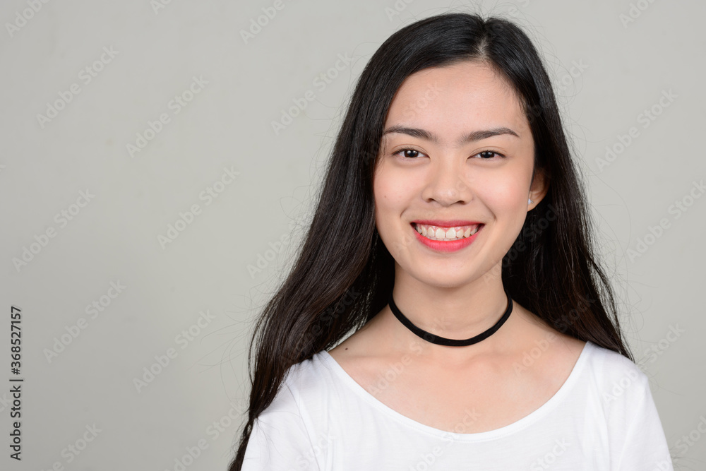 Portrait of happy young beautiful Asian woman Portrait of happy young beautiful Asian woman