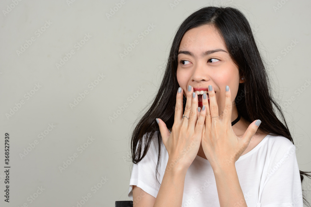 Portrait of happy young beautiful Asian woman Portrait of happy young beautiful Asian woman