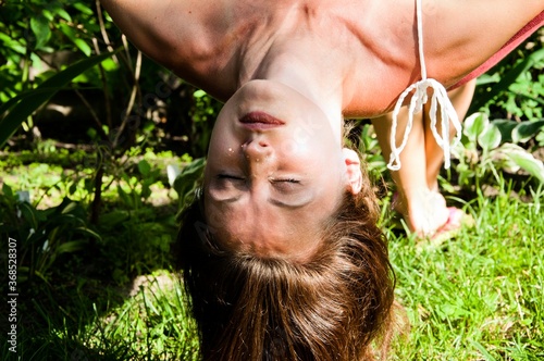 sexy woman with closed eyes. girl hangs upside down. total relaxation. feel tired in sunny day. day sleep in hammock. concept of clear and healthy skin