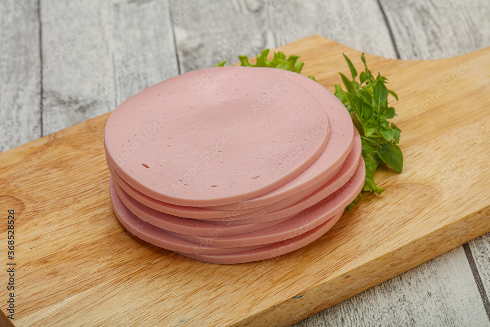 Sliced pork natural sausages over board