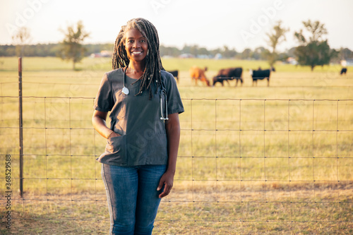 Black veterinarian on farm to check animals photo