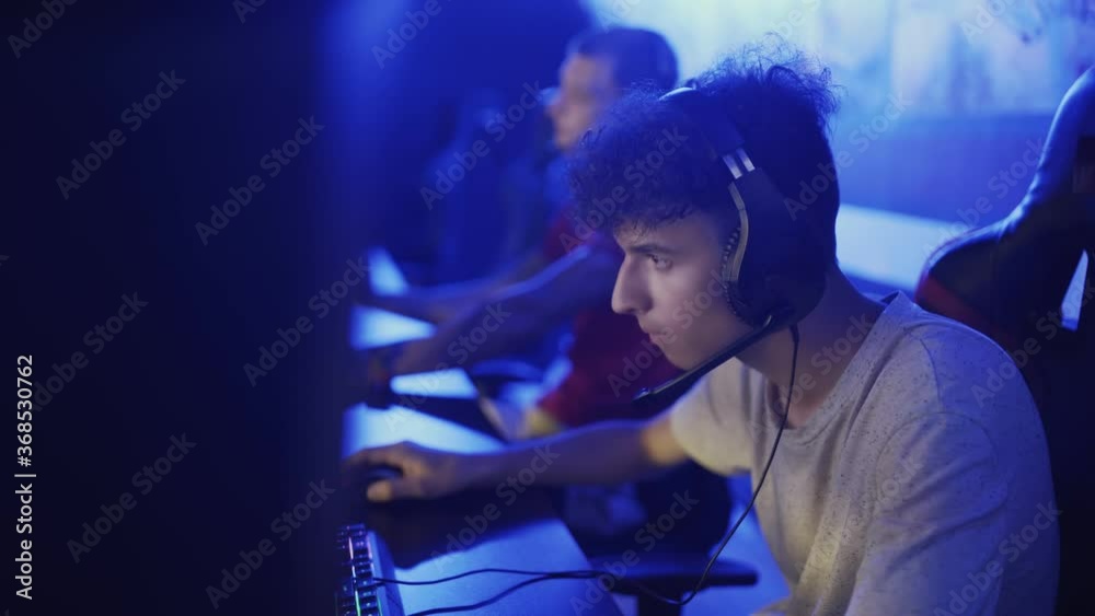 Team of Professional eSport Gamers Playing in Competitive MMORPG Strategy Video Game on a Cyber Games Tournament. Team of Professional eSport Gamers Playing in Competitive MMORPG Strategy Video Game on a Cyber Games Tournament.