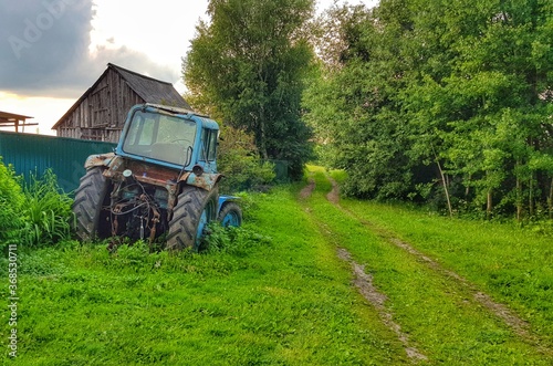 Rural landscape. There is a tractor near the road.