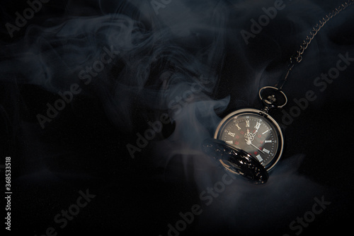 Obraz na plátne Watch vintage pocket  with smoke on black background.