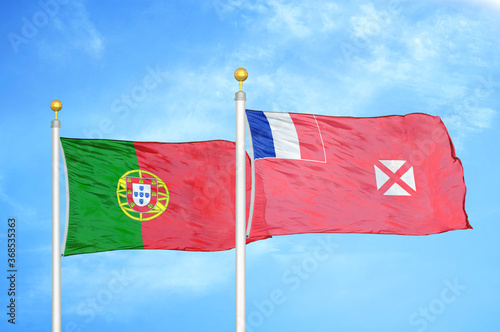 Portugal and Wallis and Futuna two flags on flagpoles and blue sky photo