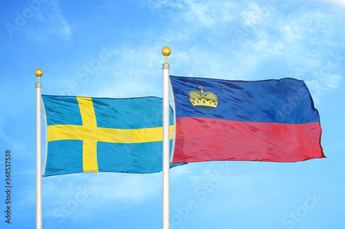 Sweden and Liechtenstein two flags on flagpoles and blue sky