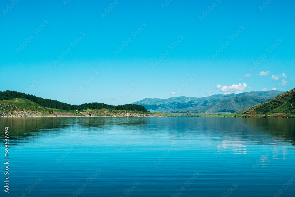 blue reservoir under blue sky