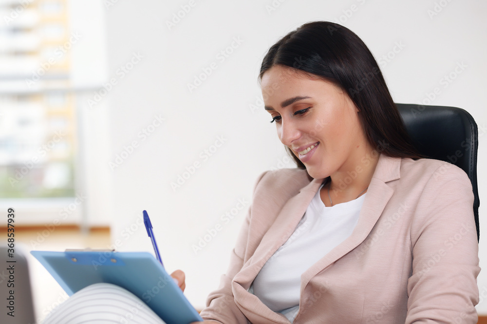 lovely young businesswoman sitting in modern office, brunette lovely young businesswoman sitting in modern office, brunette