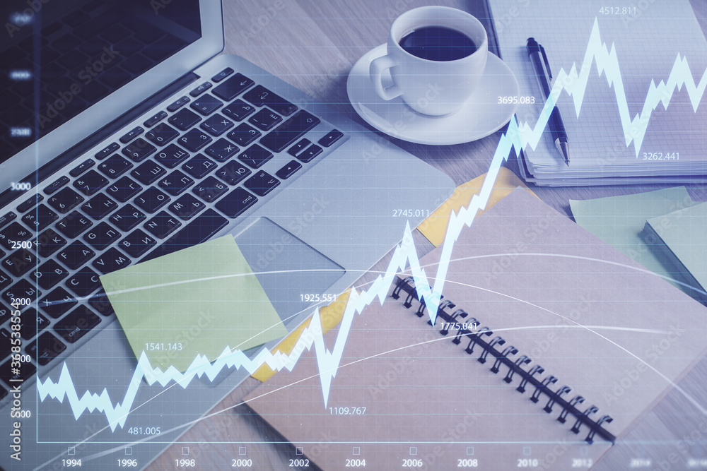Multi exposure of forex graph drawing and desktop with coffee and items on table background. Concept of financial market trading Multi exposure of forex graph drawing and desktop with coffee and items on table background. Concept of financial market trading