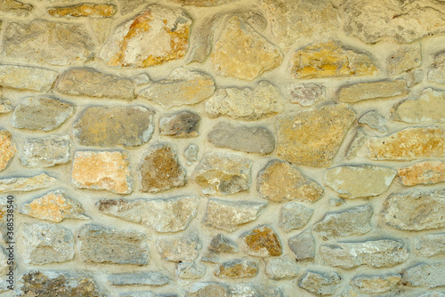 Different size stone blocks wall close up as background