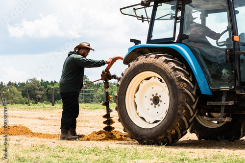 Family installing new fence on farm