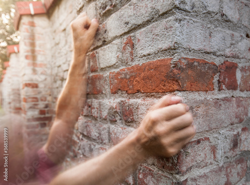 Climbers on brick wall in the city. Urban climbing on rough brickwall. Kletterer auf alter Mauer in der Stadt. Urbanes klettern auf Ziegelwand.  photo